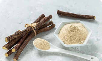 Tongkat Ali roots and powder on a gray surface